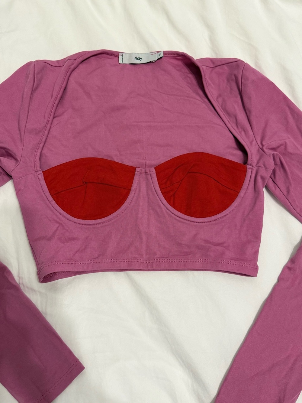 ADIKA size Small Pink Long-Sleeve Cutout Top with Red Bust Detail